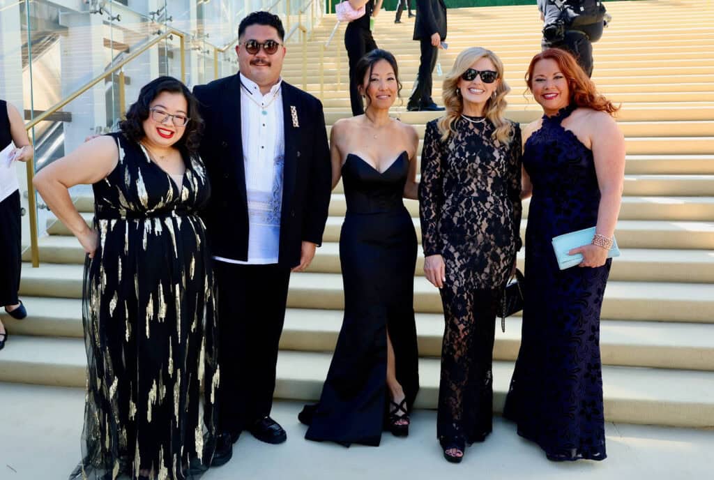Mental toughness: "Shifting the line" of your distress tolerance. 4 Joanne and The Genesis crew, dressed in formal evening wear, smile for a photo in front of wide outdoor steps. Three women wear black dresses, one woman wears a navy dress, and one man is in a black suit and bow tie.