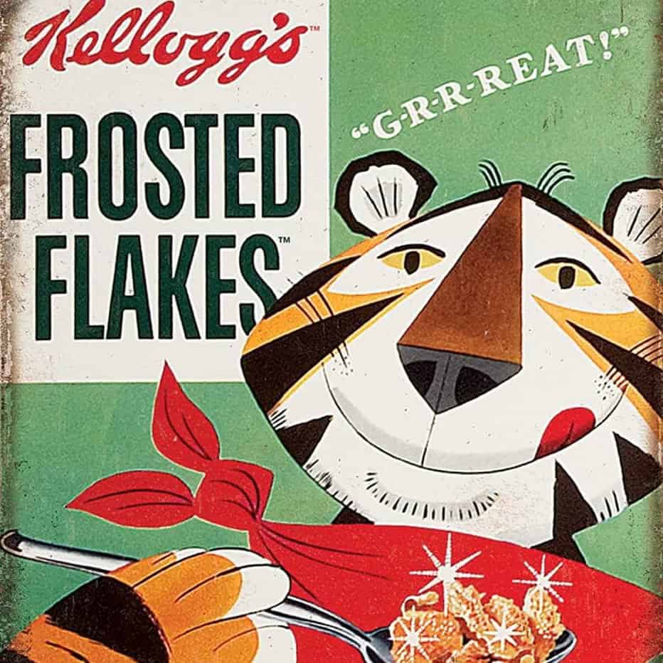 Vintage Kelloggs Frosted Flakes cereal box featuring mascot Tony the Tiger, beaming with a red scarf and spoon next to a bowl of cereal—just like mornings when your little brother hears the ice cream truck and shouts, “GRR-REAT!”.