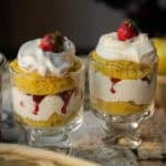 30+ AMAZING VEGAN Holiday Recipes Everyone's gonna Love. 28 Two vegan strawberry shortcake trifle glass cups filled with layered desserts: yellow sponge cake, whipped cream, and strawberries, topped with a dollop of cream and a whole strawberry on each.