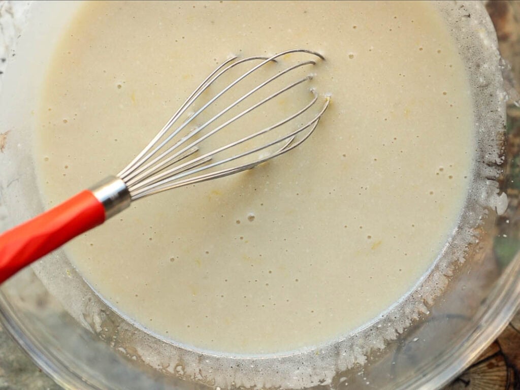 whisked together wet ingredients for lemon cake batter.