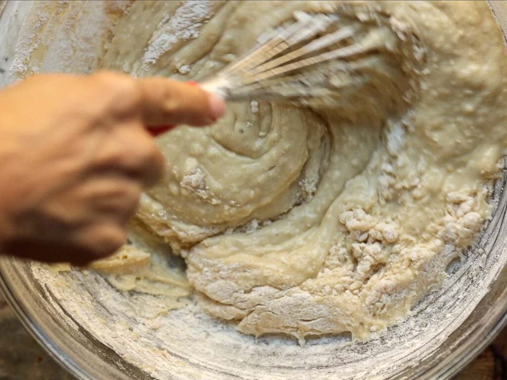 whisking together ingredients for lemon cake batter.