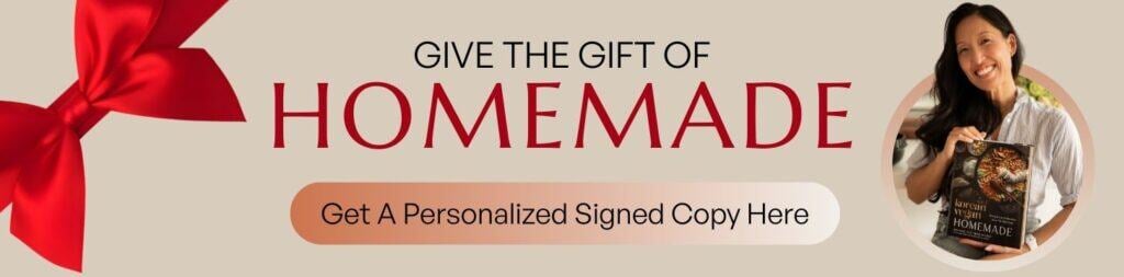 A red bow on the left, text reads Give the gift of HOMEMADE. Get a personalized signed copy here on this homemade banner. On the right, a smiling woman holds a cookbook titled Homemade.