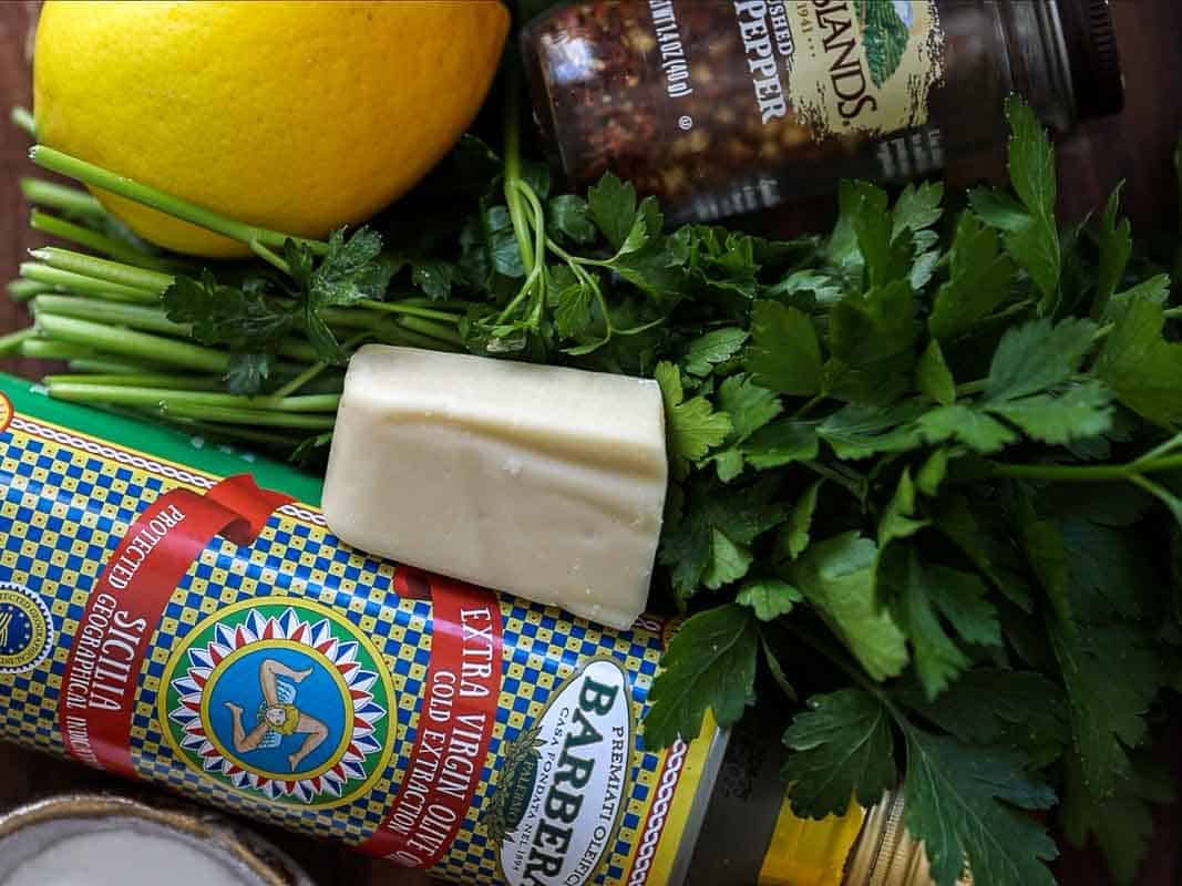 8-ingredient Easy and Delicious Lemon Pepper Pasta. 2 A close-up of fresh parsley, a lemon, Parmesan cheese, ground pepper, and extra virgin olive oil—everything you need for an easy Lemon Pepper Pasta or any delicious pasta dish.