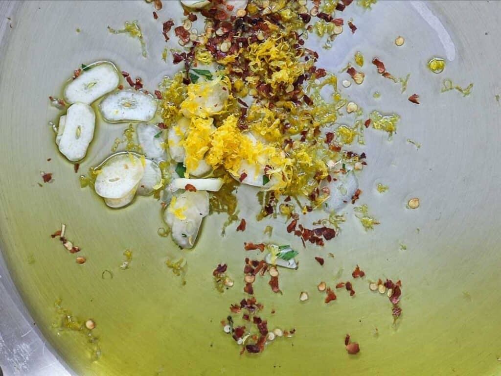 8-ingredient Easy and Delicious Lemon Pepper Pasta. 8 Sliced garlic, red pepper flakes, and lemon zest sizzle in olive oil in a pan, creating the aromatic base for this delicious Lemon Pepper Pasta.