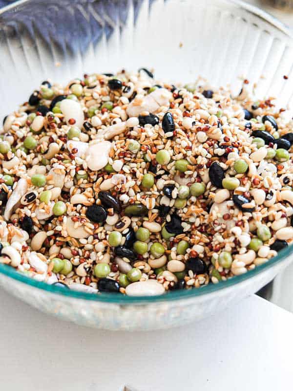 Gut Healthy Korean Multigrain Rice - Japgokbap (잡곡밥) 15 A glass bowl filled with a colorful mixture of uncooked dry beans, lentils, and grains—much like Korean multigrain rice, or Japgokbap—offers a gut healthy blend of black beans, green peas, white beans, and assorted legumes.