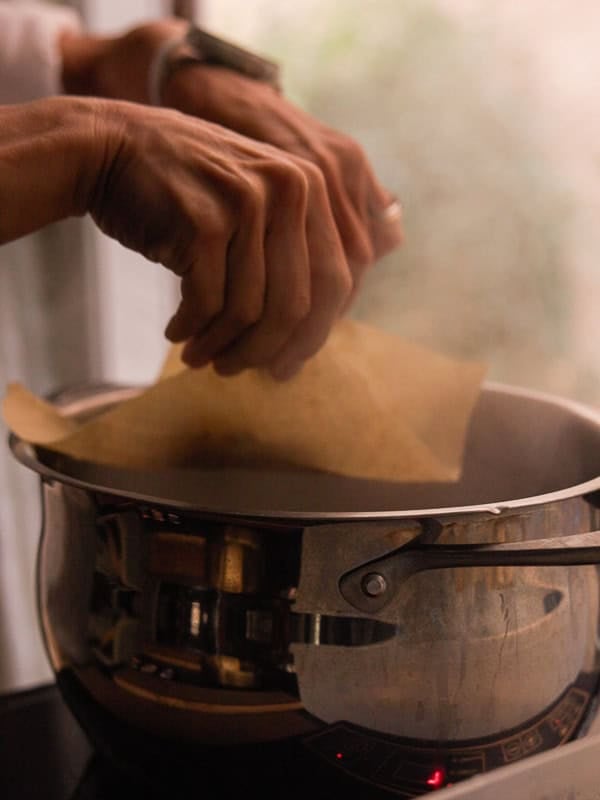 How to Make Delicious NY Style Bagels - Step by Step Guide. 59 A person’s hands are placing a sheet of pasta into a steaming pot of water on a stovetop, much like the careful preparation that goes into boiling NY style bagels.